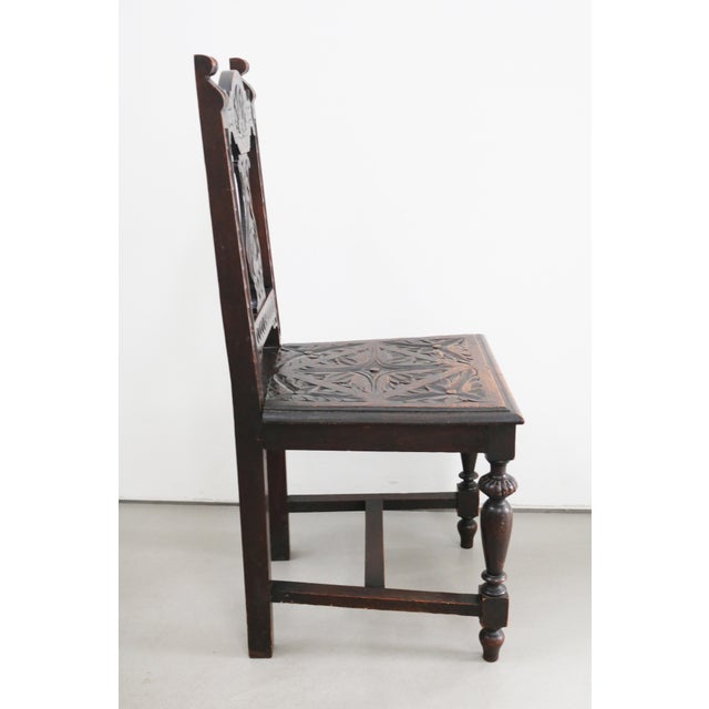 Neo-Renaissance Carved freestanding oak chair with vegetal motifs, circa 1900 Dark-stained oak Numerous carved motifs...