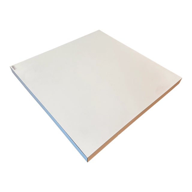 Post modern white laminate square shaped parsons style pedestal coffee table circa 1970s.