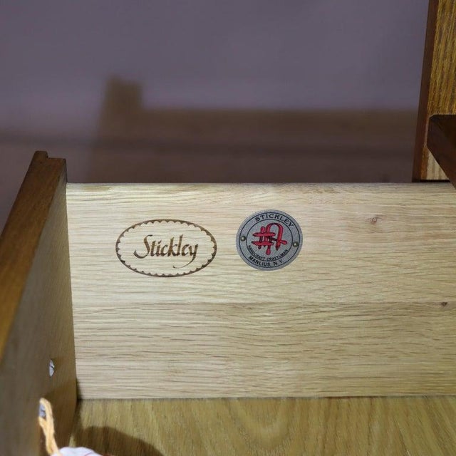 A Stickley Mission Oak two-drawer entertainment cabinet, crafted from quarter-sawn oak in the 20th century, embodies the...