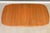 A mid century modern teak dining table with one 18.75” leaf and a pedestal base. Made in Canada. Professionally...