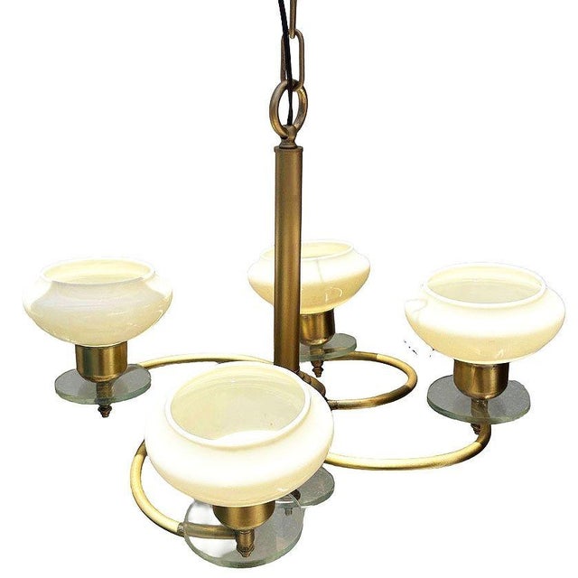 Elegant Scandinavian Art Deco chandelier featuring four Opaline glass bowl shades suspended from a streamlined brass...