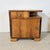 A beautiful set of two mirrored bedside tables in a distinct Art Deco and Streamline Moderne style from the 1950s. This...