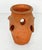 A fine vintage English round garden planter pot or urn of patinated terracotta, featuring pierced holes around the...