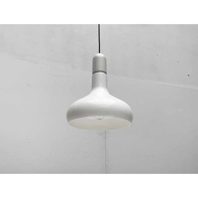 Simple Space Age pendant lamp from the renowned manufacturer Staff. The lamp is divided into two parts. The upper hood of...