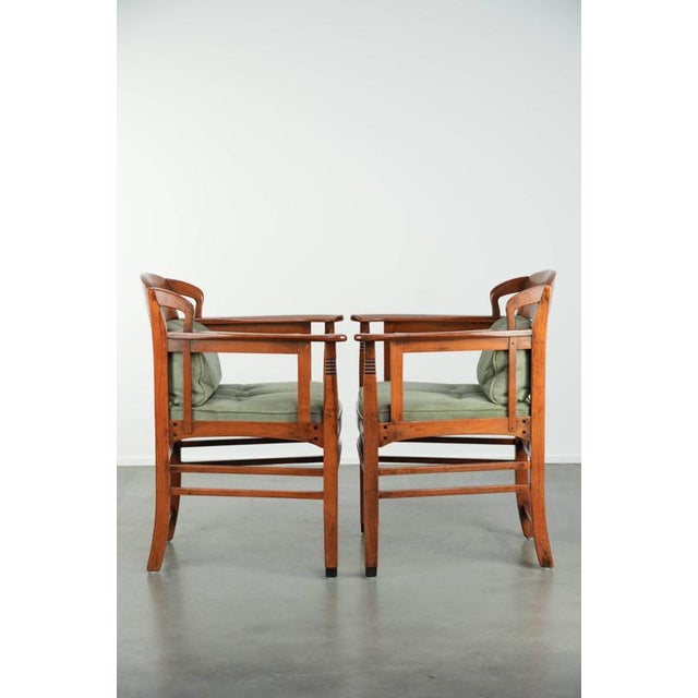 This unique set of 2 dining chairs features mint green suede/fabric upholstery and comes from the Art Nouveau/Jugendstil...