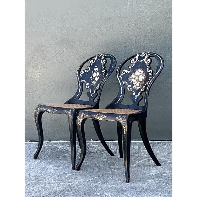 This rare pair of Victorian papier-mâché side chairs represents the height of 19th-century decorative opulence....