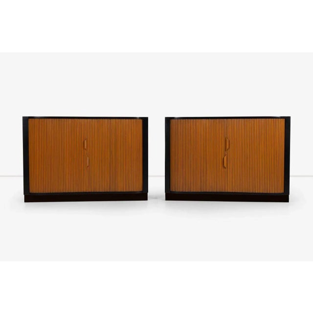 Edward Wormley Mr. and Mrs. Tambour Chests, models 4723 and 4724, bleached mahogany cases on leather wrapped plinth bases....