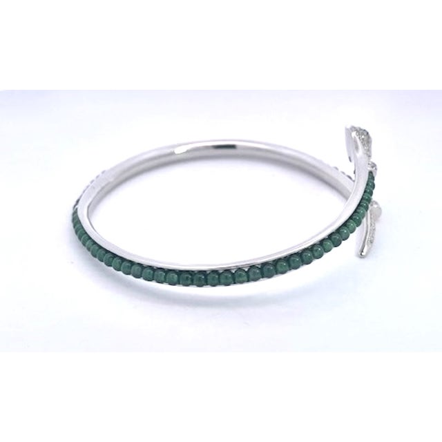 Elegantly crafted in base metal this captivating serpent wrap bangle exudes timeless allure. The open-ended bypass design...
