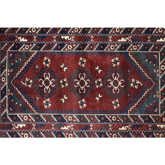 This oriental Afghan rug was made in Afghanistan during the 1970s. This rug is dyed in shades of red and turquoise. It is...