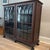 Gorgeous claw foot china cabinet/bookcase featuring gothic style paned glass doors. Excellent condition for age. Does have...