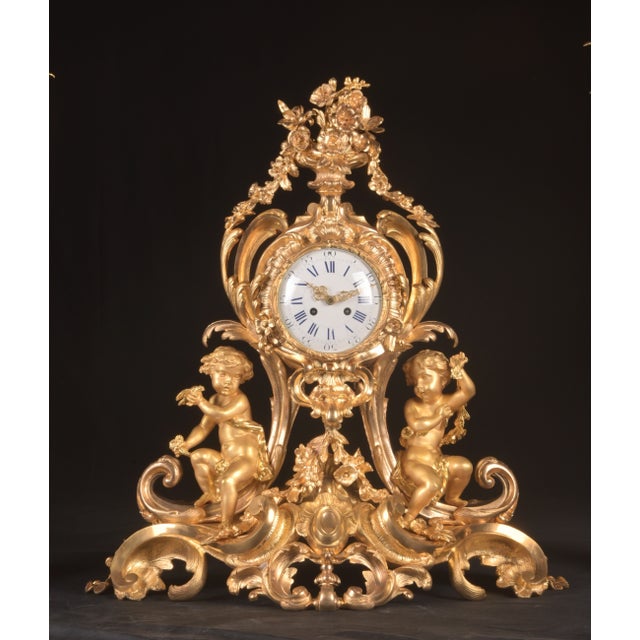 This monumental and breathtaking French Louis XV clock set, dating from approximately 1840–1860, is an exceptional three-...