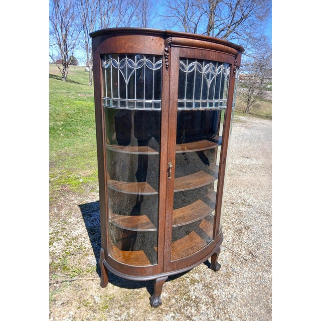 Antique Quartersawn Oak Leaded Curved Glass China Cabinet with Claw Feet 1920s A Victorian antique 1920s china cabinet...