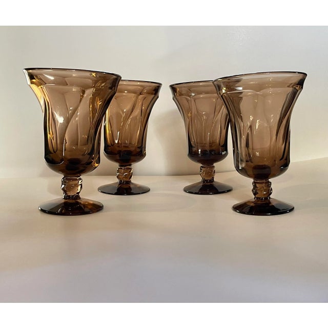 A beautiful vintage set of iced tea goblets on a round foot with a faceted stem in swirled tan glass made by the Fostoria...