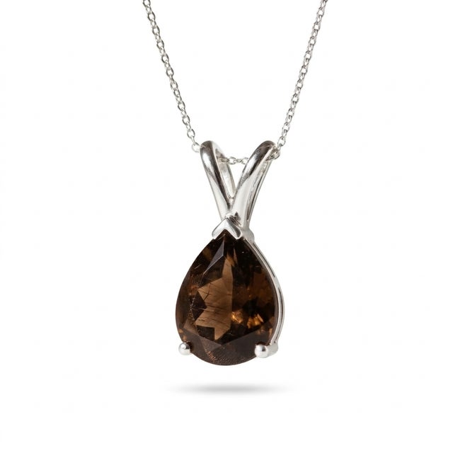This elegant pendant showcases a rich and earthy Smoky Quartz gemstone, admired for its deep brown tones and subtle,...