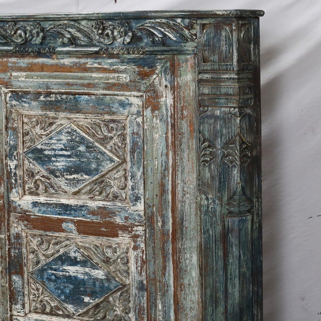 A king-size headboard made from an antique painted Indian teak window framed with carved pillar elements. Rich in texture...