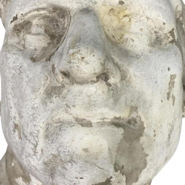 An evocative hollow-cast plaster portrait head of a man, modeled with strong, expressive features and an unusual upward-...