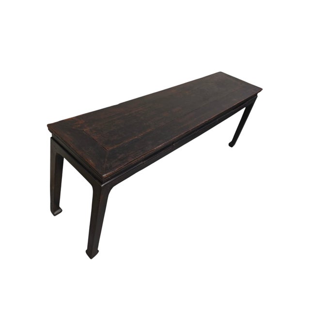 This 18th century console table features a very long, narrow design with a black finish that shows off the wood grain. It...
