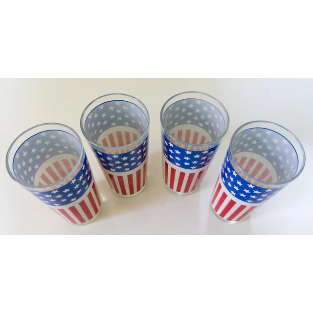 1970s set of 4 glass tumblers with stars and stripes US flag design printed on all of them. The glass is in excellent...