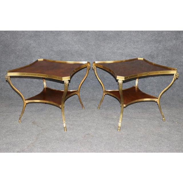 An exceptional and highly decorative pair of Regency-style mahogany and brass-mounted two-tier side tables, dating to...