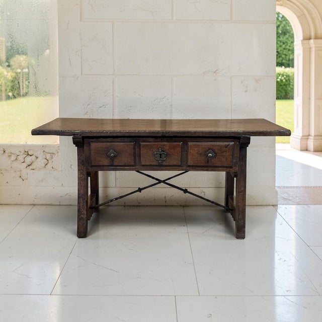 A rare 17th century rustic Spanish table in walnut, now enjoyed as a coffee table, with a generous rectangular top and the...
