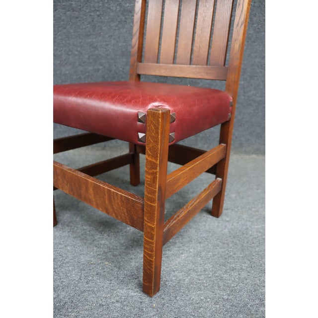 Classic Warren Hile Studios Mission oak desk chair featuring a slatted back and solid oak construction. The chair has a...
