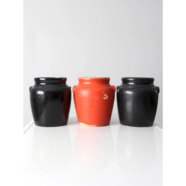 This is a collection of three vintage Ransburg cookie jars circa 1930-1950. The set includes two black jars and one...