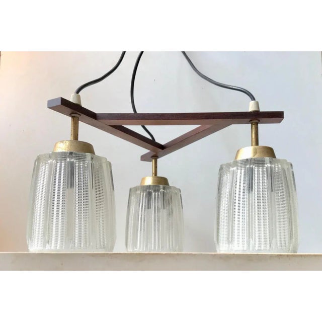 This mid-century Modern 3-shaded chandelier was manufactured in Denmark during the late 1950s in a style inspired by...