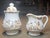 This gorgeous, unmarked sugar and creamer set in the “Willow Tree” pattern is crafted from fine English hard paste...
