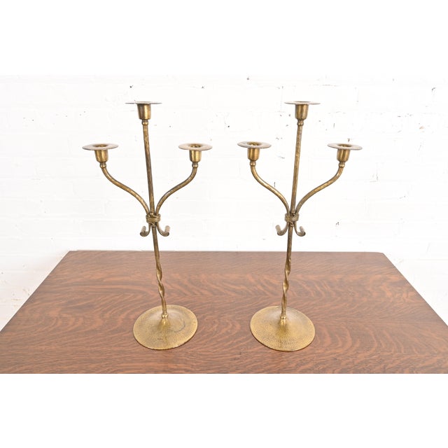 A gorgeous pair of Arts & Crafts period brass finished hand hammered copper candelabras By Roycroft (signed with impressed...
