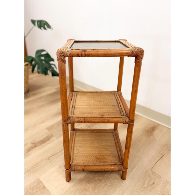 This charming vintage woven rattan end table that can double as a shelf with glass top is a warm and practical coastal and...