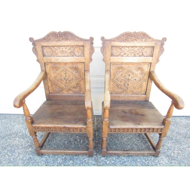 Pair of antique English Jacobean style solid oak armchairs, c.1880 A good looking pair of chairs with heavily carved back...