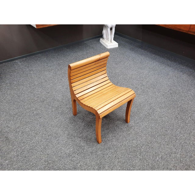 Likely a very rare and beautifully designed solid wood children's chair. Handcrafted. Eighteen wooden slats form the seat...