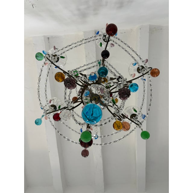 Housing 6 lights, sitting in crystal cups, dripping with different color prisms. This will be rewired using a certified US...