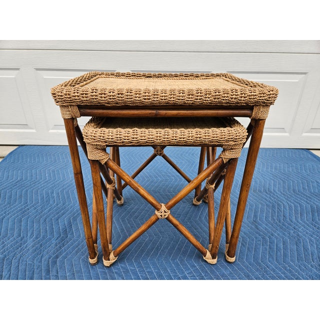 A pair of nesting bamboo, rope and grass mat nesting tables in good vintage condition. This pair of tables is sturdy and...