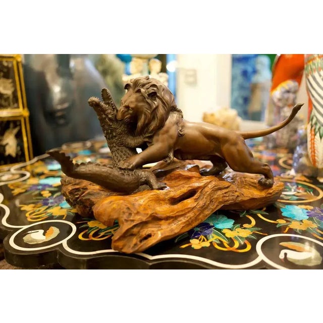 A Stunning 19th Century Bronze lion And Crocodile on Hardwood Base. The artist has illustrated a powerful image and...