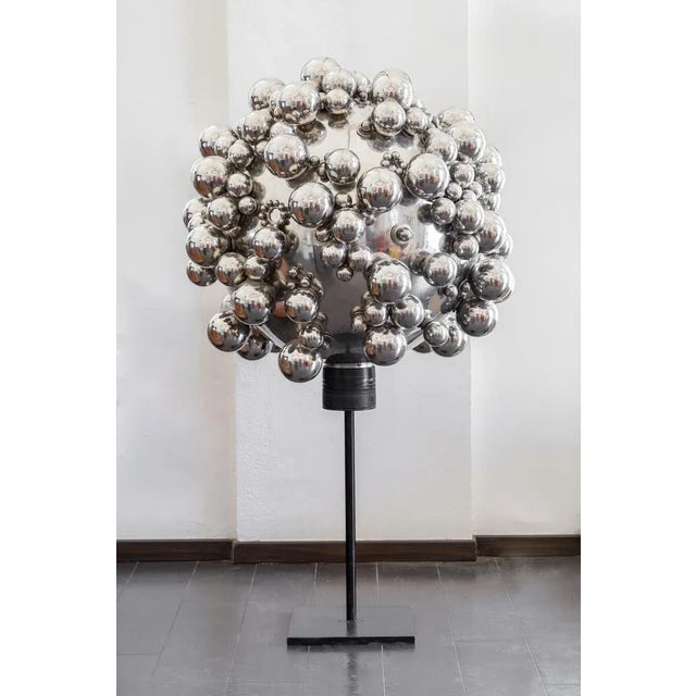 Unpublished steel sculpture formed by spheres of various sizes, the sculpture is mounted on a raw iron pedestal. Italian...