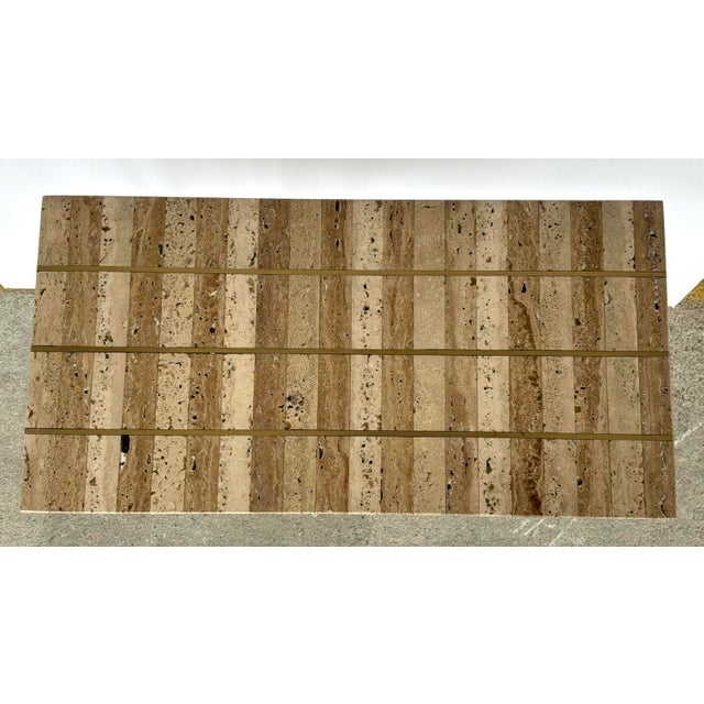 Original retail $1340, stylish Currey & Company Travertine and Brass Dezi C Cantilever Side Table, showroom floor sample