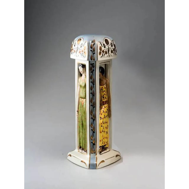 Ceramic production duchaussy with triangular section, polychrome decoration depicting three young women symbolizing...