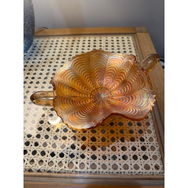 Carnival glass, also known as iridescent glass, was produced from the late 19th century through the mid-20th century, with...