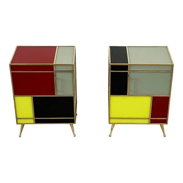Pair of single-door bedside tables, entirely handmade, wooden frame covered in stained glass, trim, handles, and feet in...