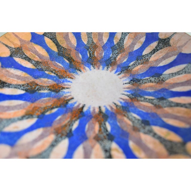 Colored enamel wall plate by designer Margarethe Ernst from the 1960s. On the back there is a wall mount with Margarethe...