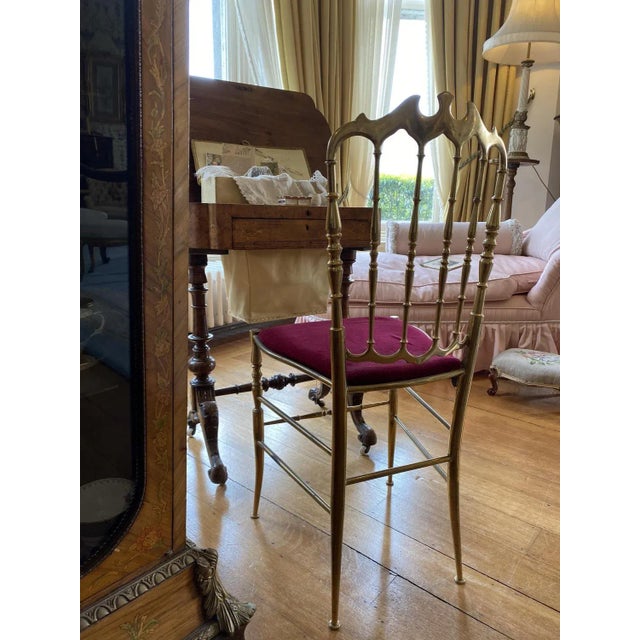 Elevate your interior space with this exquisite solid brass Chiavari chair, recently re-upholstered in luxurious red...