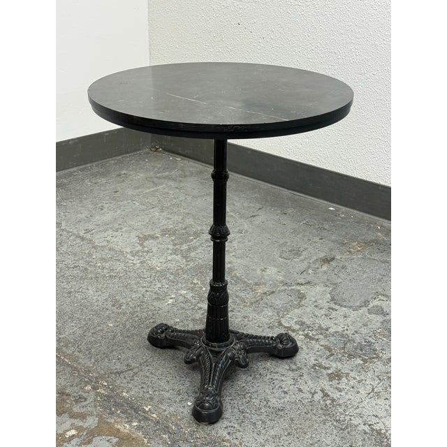 Design Plus Gallery presents an Industrial Marble Top Bistro Table. The circular charcoal marble top displays natural gray...