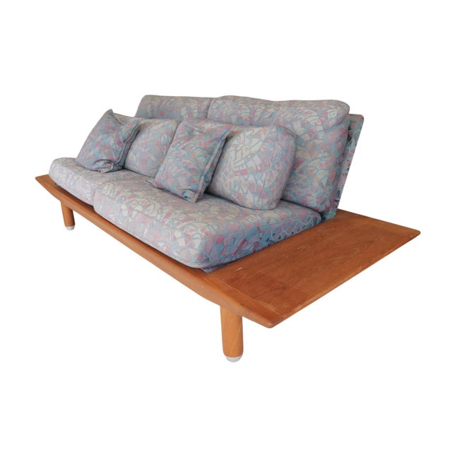 A Danish modern Gondola settee by Komfort furniture. Made of teak with eight cushions upholstered in the original fabric....