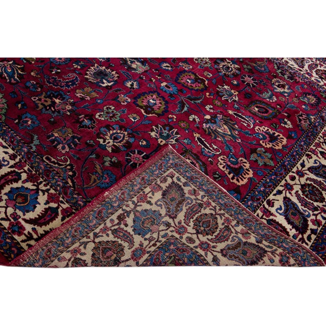 Beautiful Mashad hand-knotted wool rug with the red field. This piece rug has a beige-designed frame in a gorgeous all-...