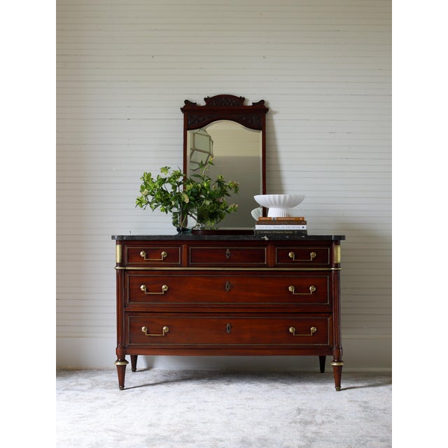 This 19th century French Louis XVI commode reflects the lasting influence of the Neoclassical style in France following...