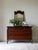 This 19th century French Louis XVI commode reflects the lasting influence of the Neoclassical style in France following...