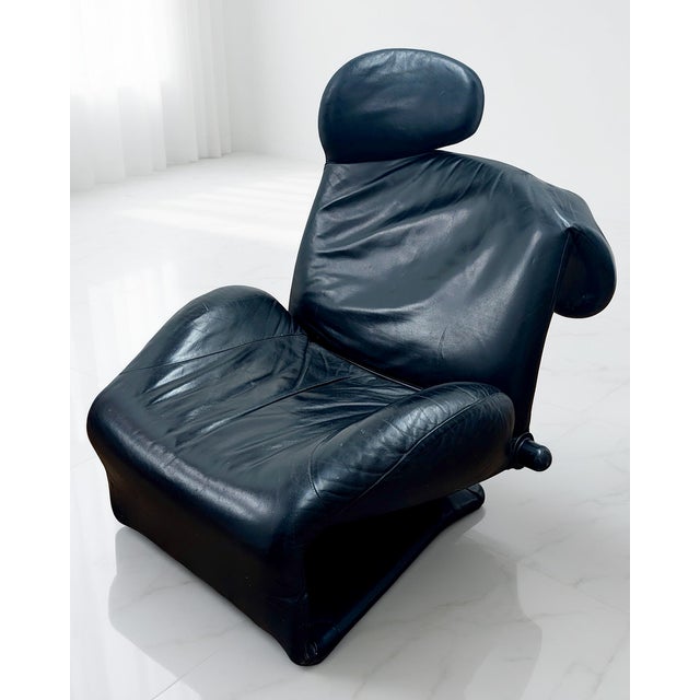 This is a black leather Wink lounge chair designed by Toshiyuki Kita for Cassina, 1980s. Wink is a versatile, eclectic...