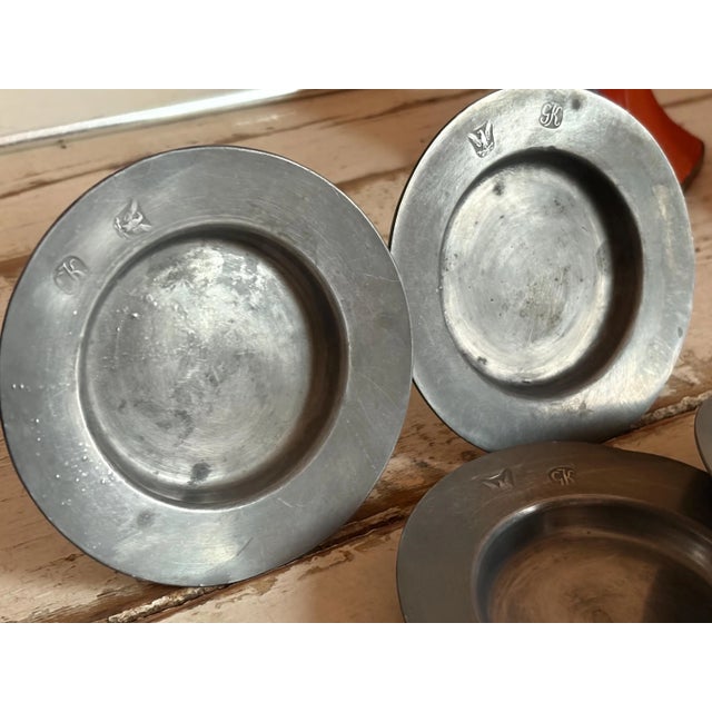 This is a very hard to find pewter set with stamped initials “GK” next to an eagle crest with two arrows. These would have...