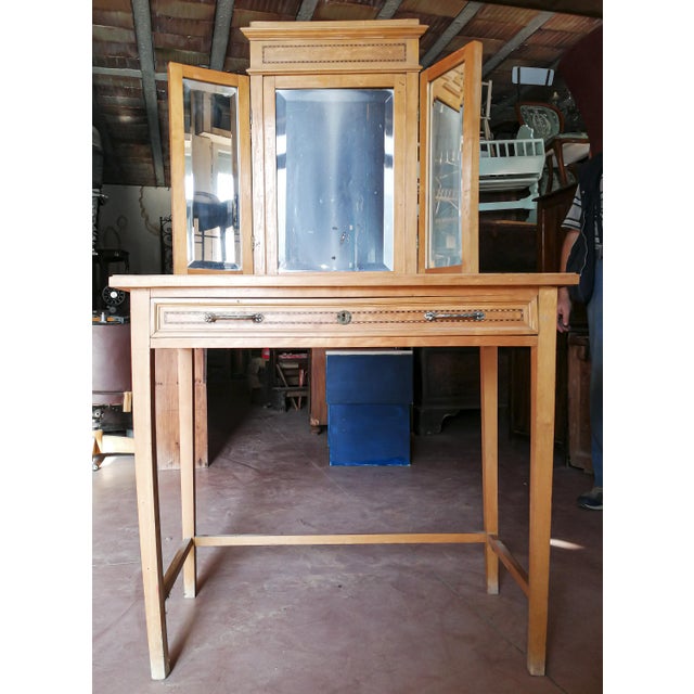 This dressing table desk, made of light wood with a walnut effect, features an art nouveau design with a three-door mirror...